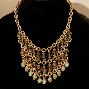 Gold costume jewelry with amber/white transluscent bib necklace.